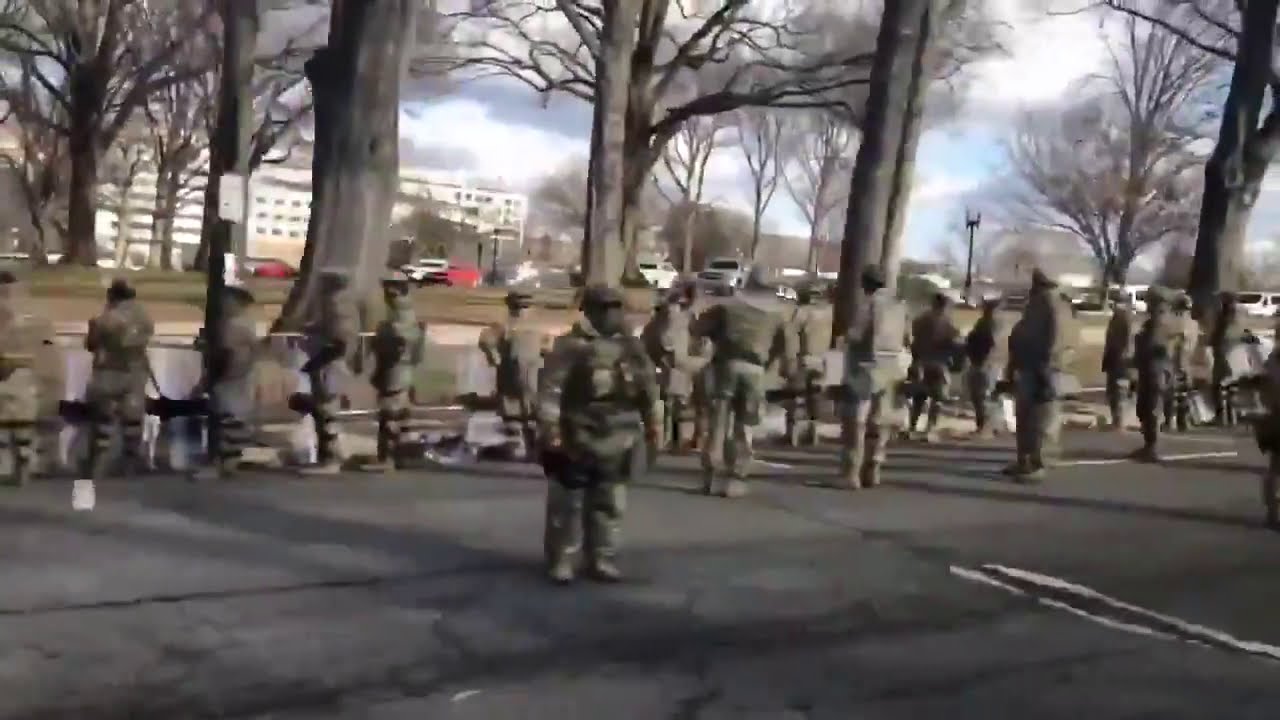 Military turns backs to Joe Biden's motorcade.